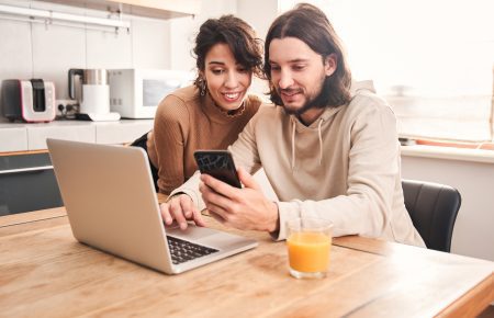Couple checking deal in front of laptop | CarMoney.co.uk