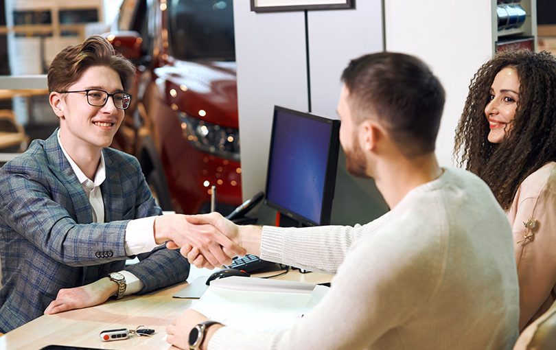 Man and women making a deal at dealer | CarMoney.co.uk