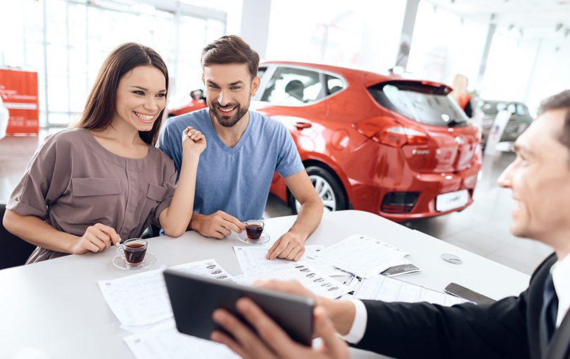 Man and woman at the dealer | CarMoney.co.uk